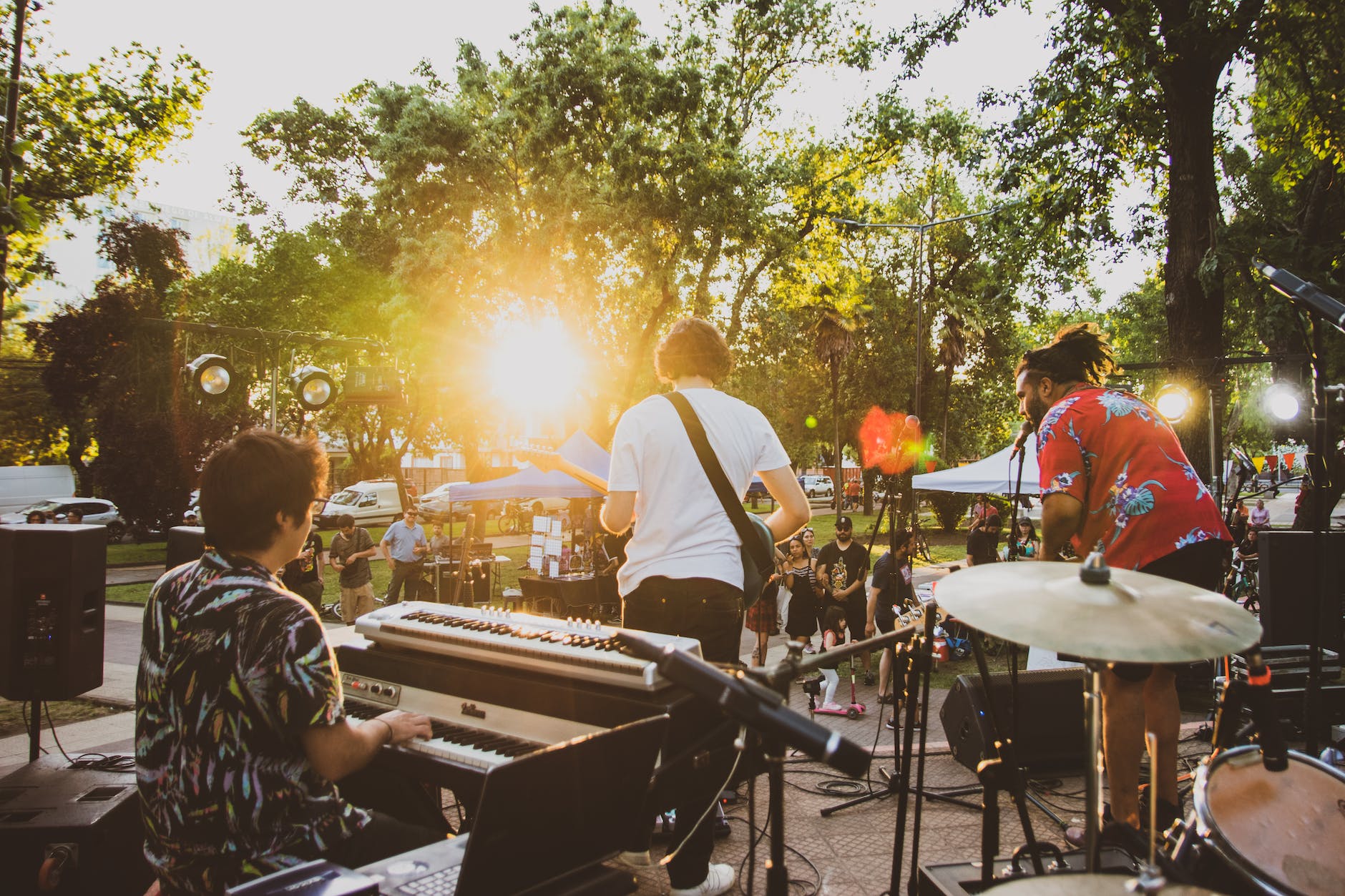a band playing music in a park in summer